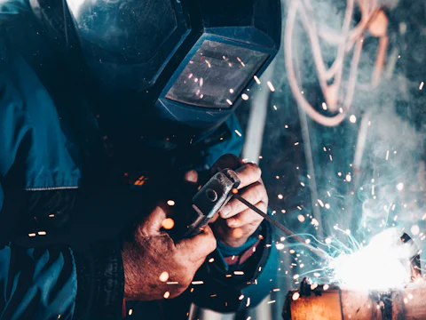 Welder in a welding mask with sparks flying